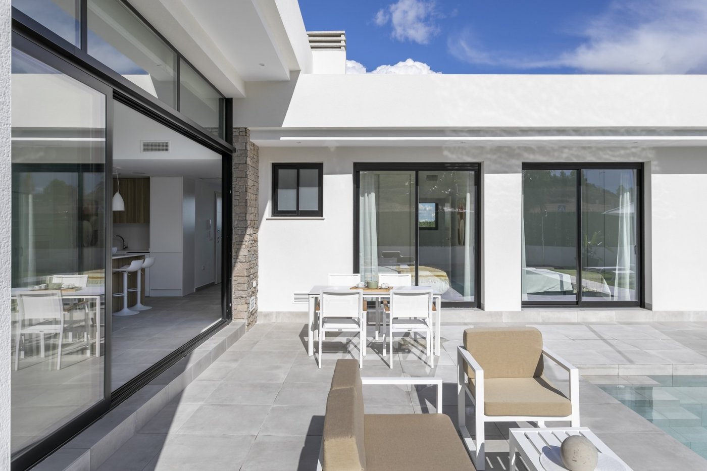 Sun-drenched terrace and private pool of spacious new build 3-bedroom villa in Calasparra, Murcia with modern outdoor seating.