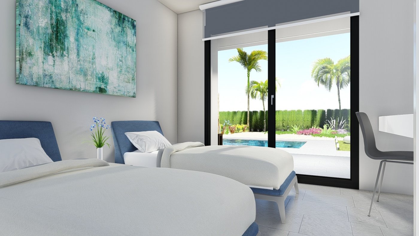 Bright, modern 2-bedroom villa bedroom in Calasparra, Murcia with sliding doors opening to a private pool and landscaped garden.
