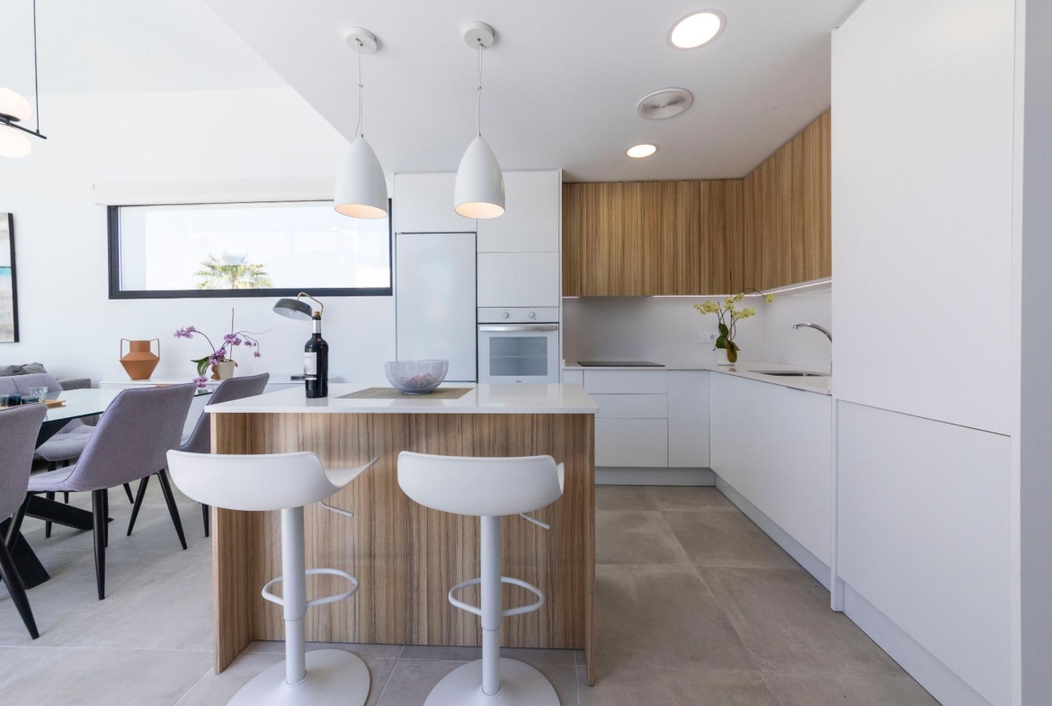Bright modern kitchen with sleek wood accents and open-plan dining in luxury 3-bedroom villa, Calasparra, Murcia
