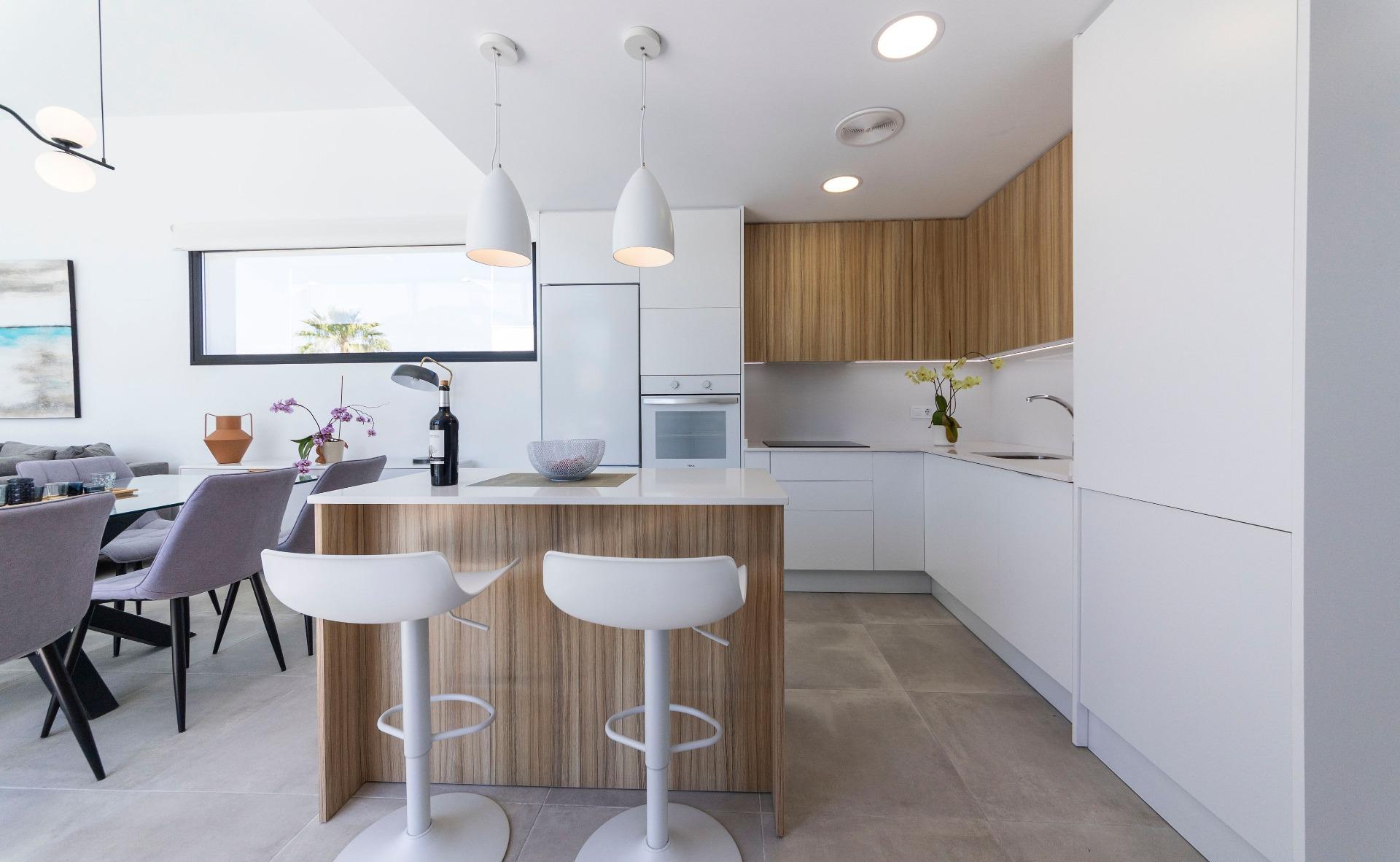 Bright modern kitchen with sleek wood accents and open-plan dining in luxury 3-bedroom villa, Calasparra, Murcia