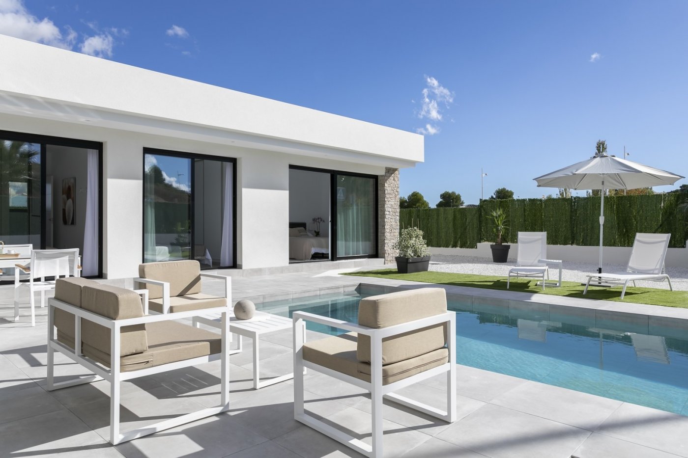 Modern spacious 3-bedroom villa in Calasparra with a private pool, stylish outdoor seating, and sunlit terrace under a blue sky.