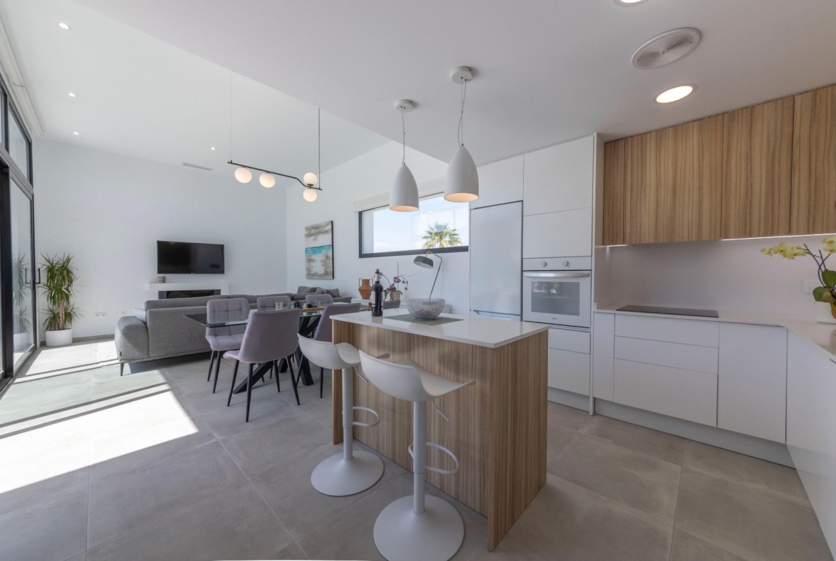 Bright modern open-plan kitchen and living area with sleek cabinetry in 3-bedroom villa for sale in Calasparra, Murcia