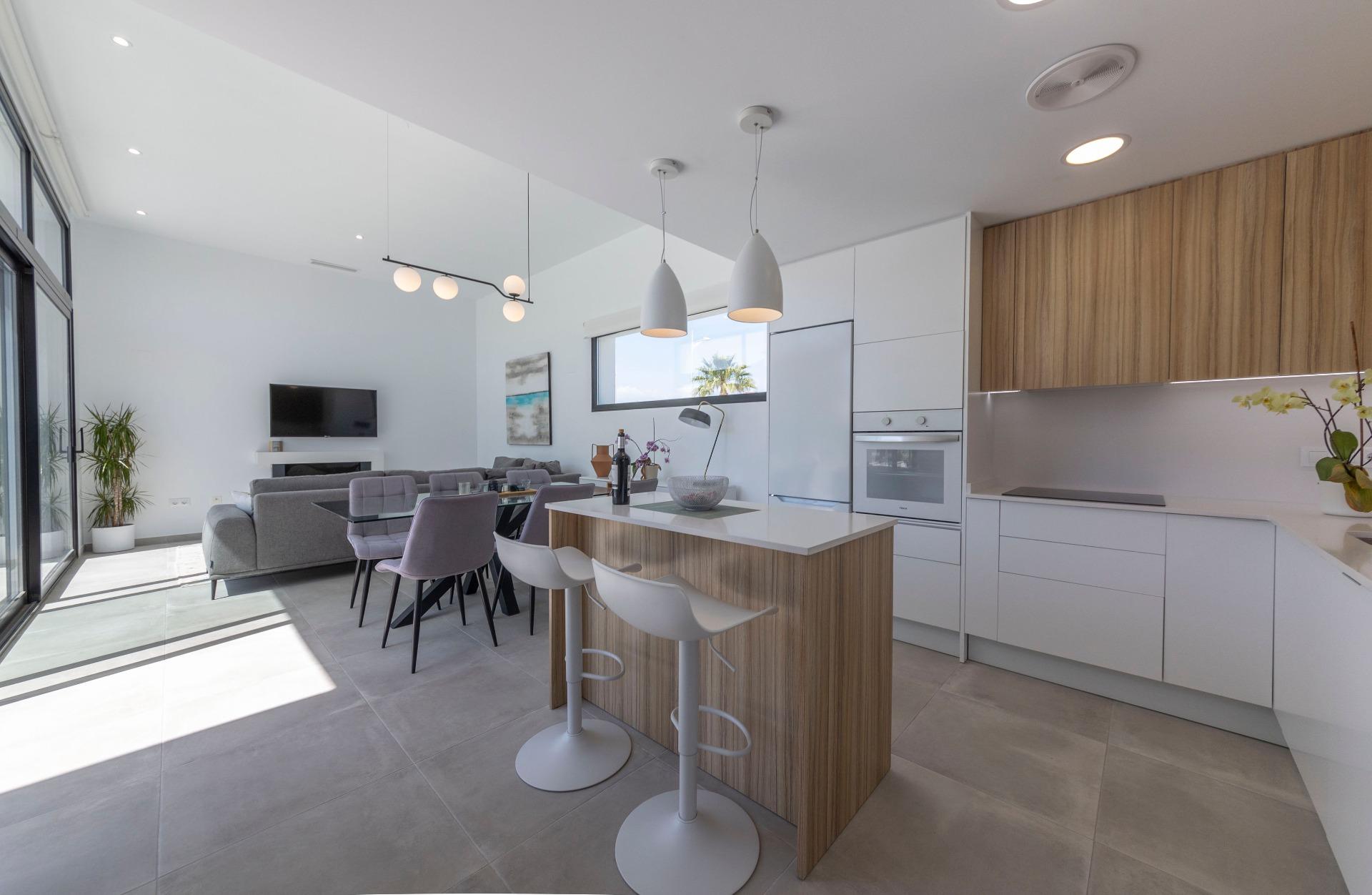 Bright modern open-plan kitchen and living area with sleek cabinetry in 3-bedroom villa for sale in Calasparra, Murcia