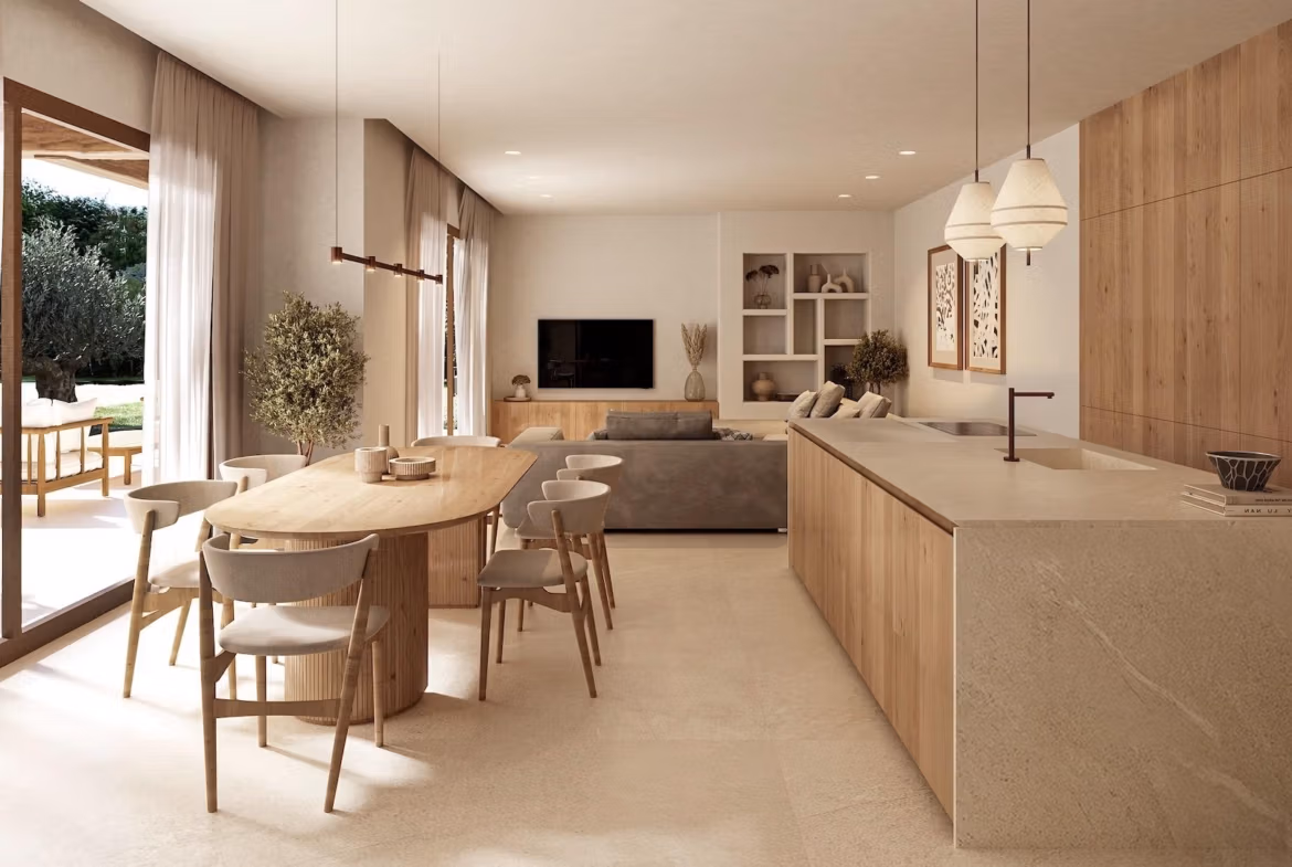 Bright open-plan kitchen and dining area with natural wood accents in a charming Ibizan-style villa in La Fustera, Benissa.