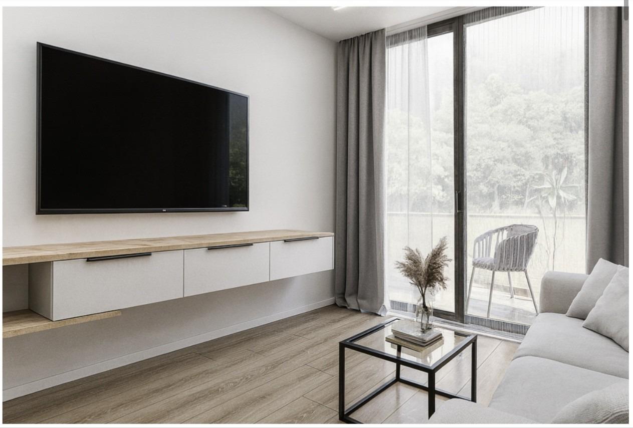 Bright modern living room with sleek TV, minimalist furniture, and balcony in new 2-bedroom apartment in Torrevieja near Playa El Acequión