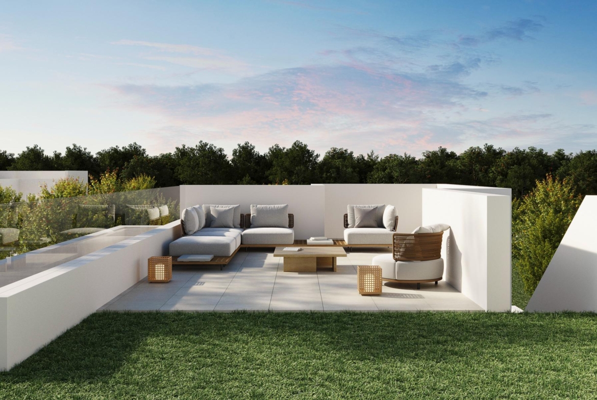 Elegant outdoor lounge with modern seating and glass railing overlooking lush greenery at luxury 5-bedroom villa in Polop de la Marina.