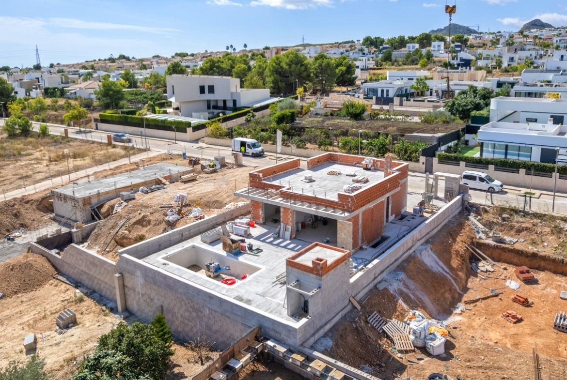 Under-construction luxury 5-bedroom villa in Polop de la Marina with expansive terraces and panoramic mountain and sea views.