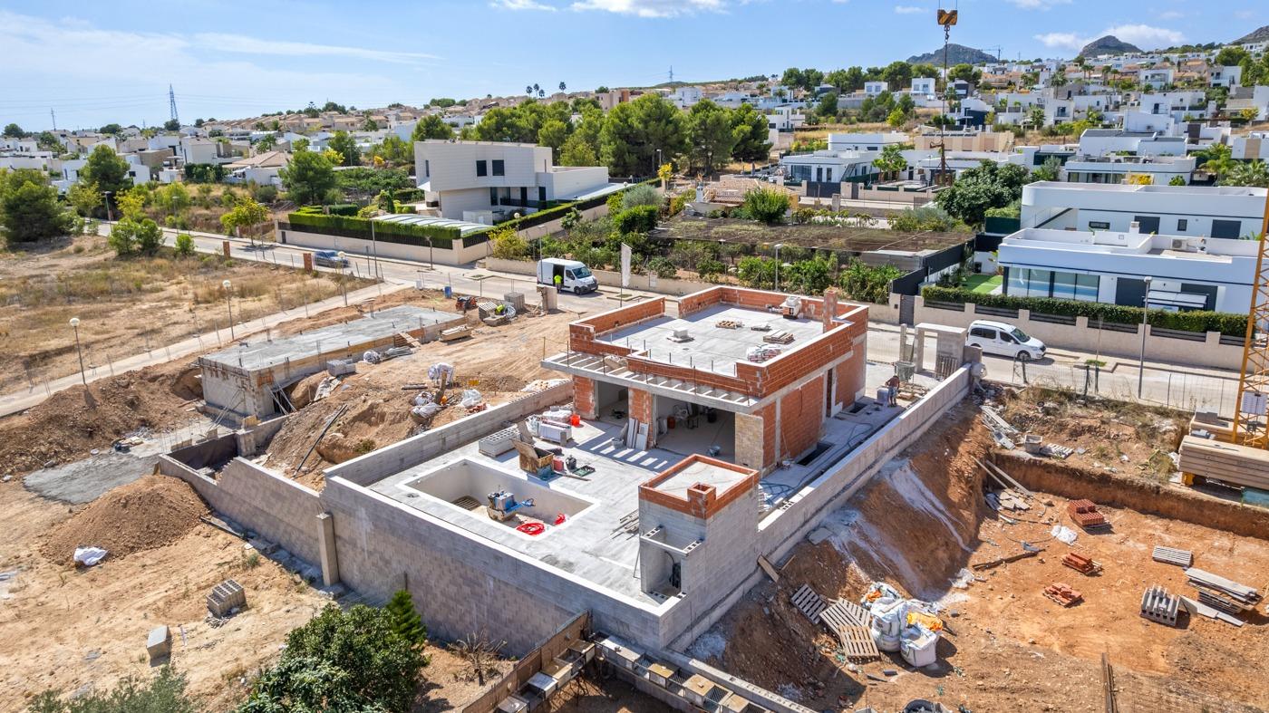 Under-construction luxury 5-bedroom villa in Polop de la Marina with expansive terraces and panoramic mountain and sea views.