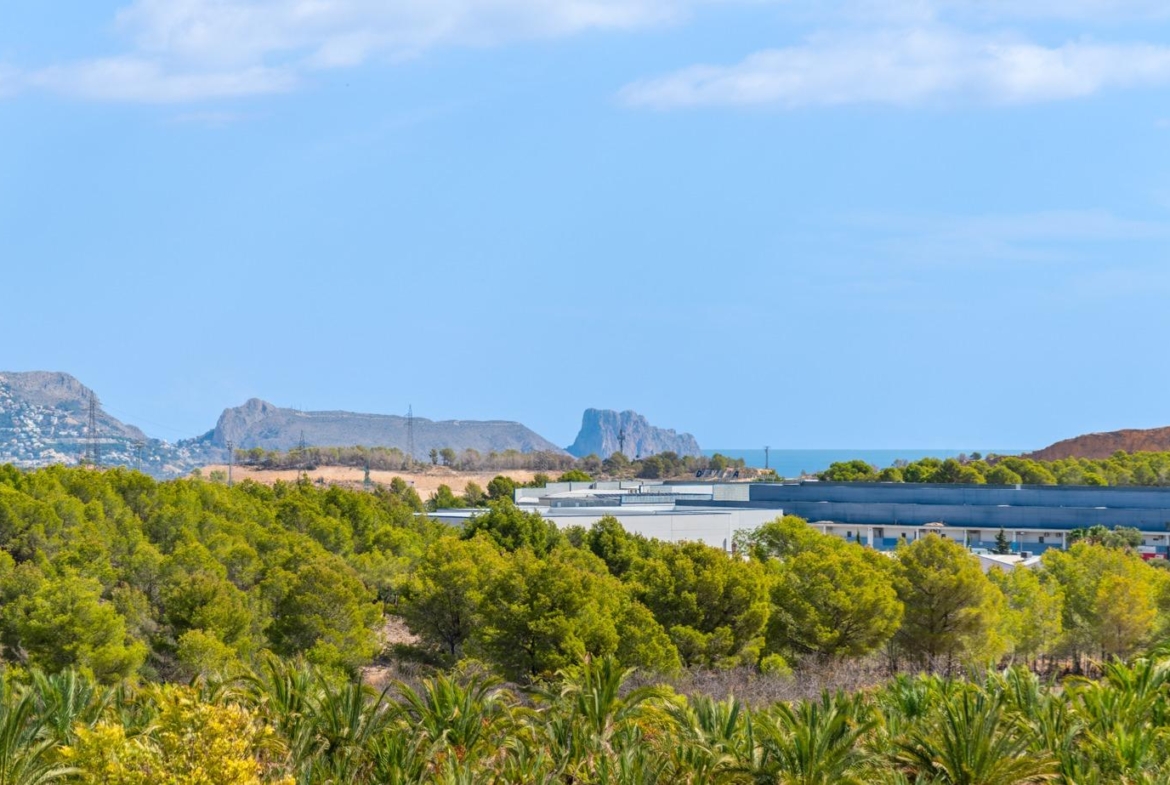 Expansive sea and mountain views behind lush greenery from a luxurious 5-bedroom villa in Polop de la Marina