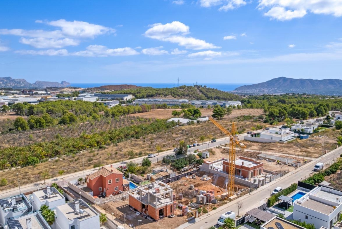 Expansive luxury 5-bedroom villa under construction in Polop de la Marina with panoramic sea and mountain views.