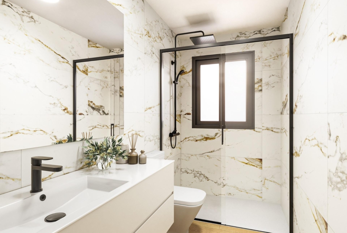 Modern luxury bathroom with sleek black fixtures and marble walls in a stylish new build 2-bedroom apartment in Torrevieja.