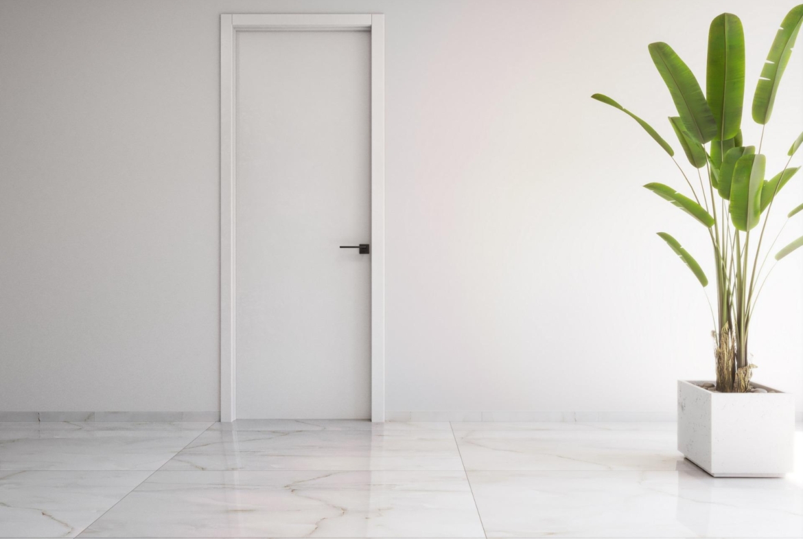 Minimalist bright room with sleek marble floor and vibrant green plant in modern 2-bedroom ground floor apartment in Torrevieja.