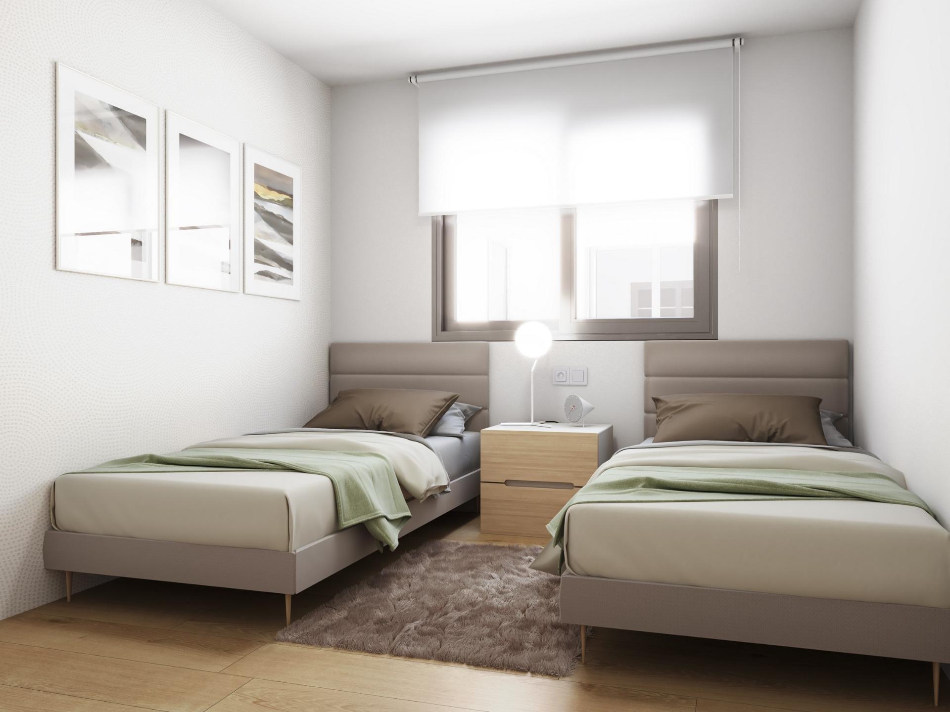 Bright modern twin bedroom with neutral tones and soft natural light in a new build ground floor apartment in Torrevieja.
