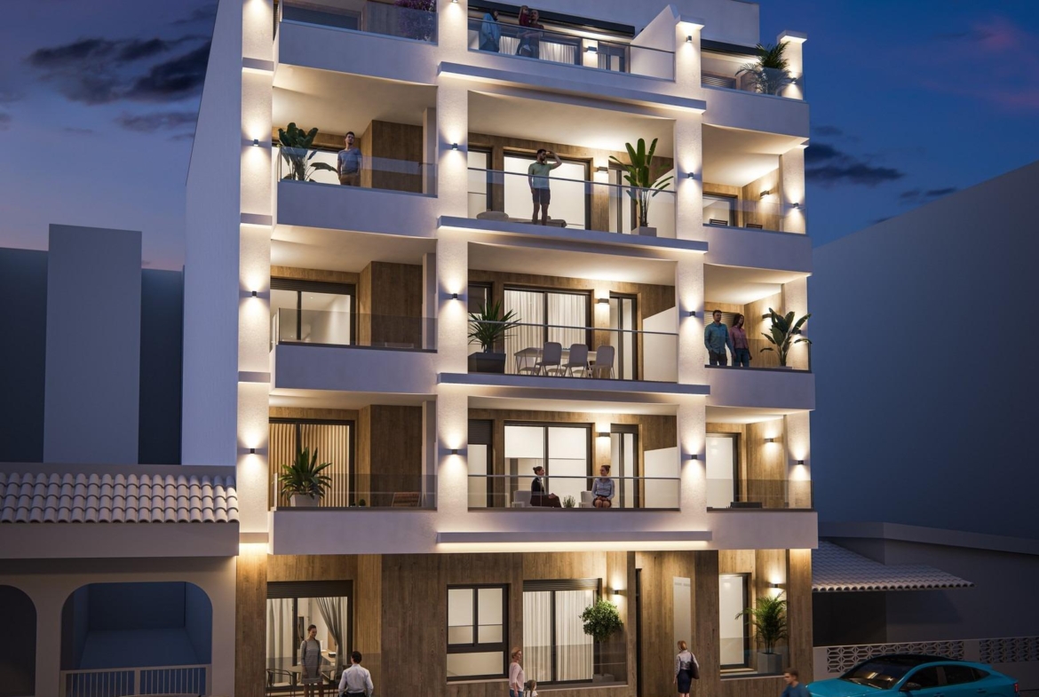 Elegant modern 2-bedroom ground floor apartment building with illuminated terraces and balconies in vibrant Torrevieja near Playa del Cura.