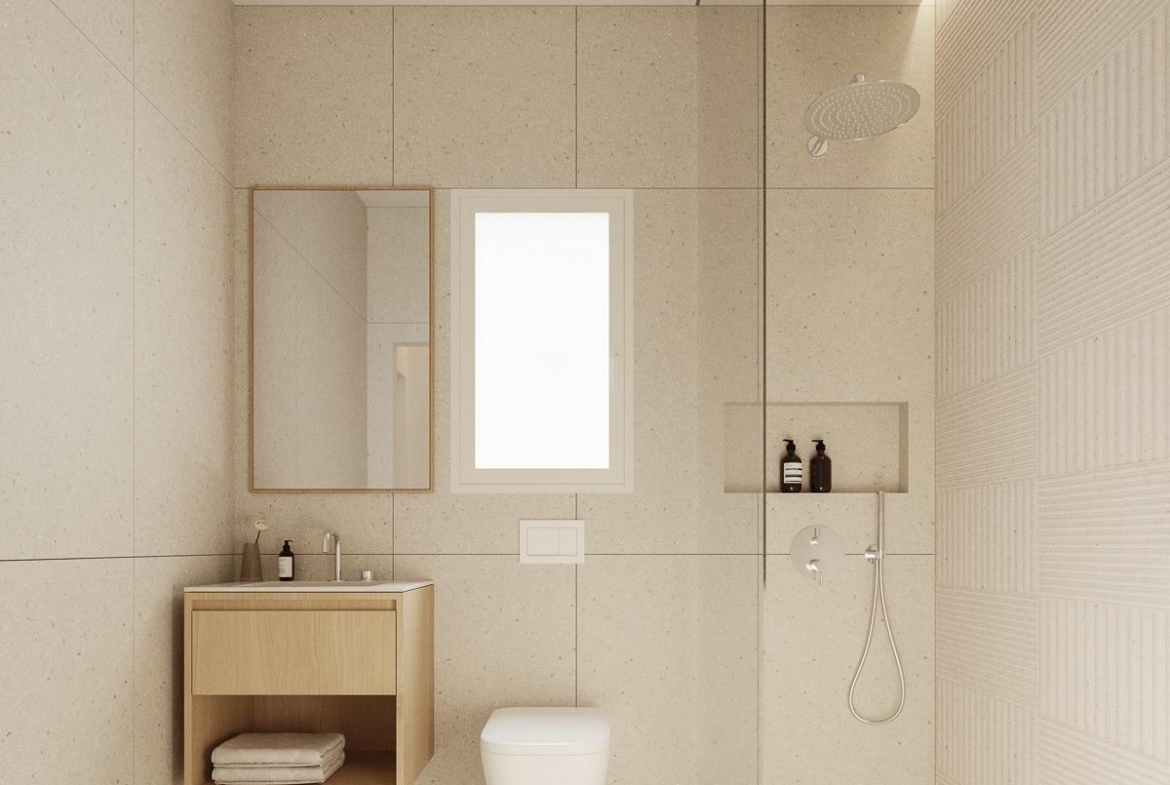 Bright, modern bathroom with walk-in shower and sleek fixtures in spacious new build 2-bedroom apartment in central Torrevieja.