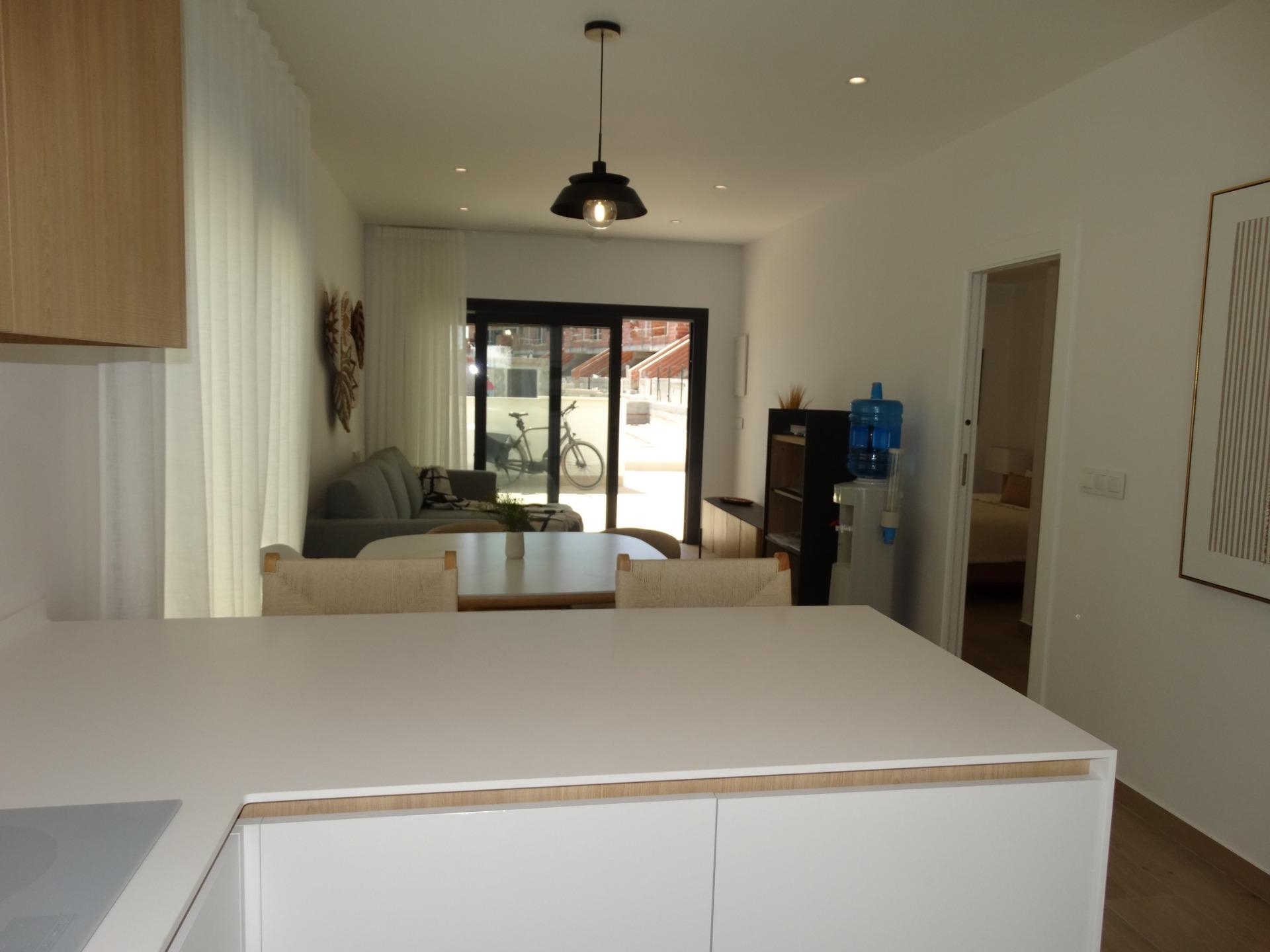 Bright modern open-plan living and dining area in a new build bungalow for sale in Pilar de la Horadada