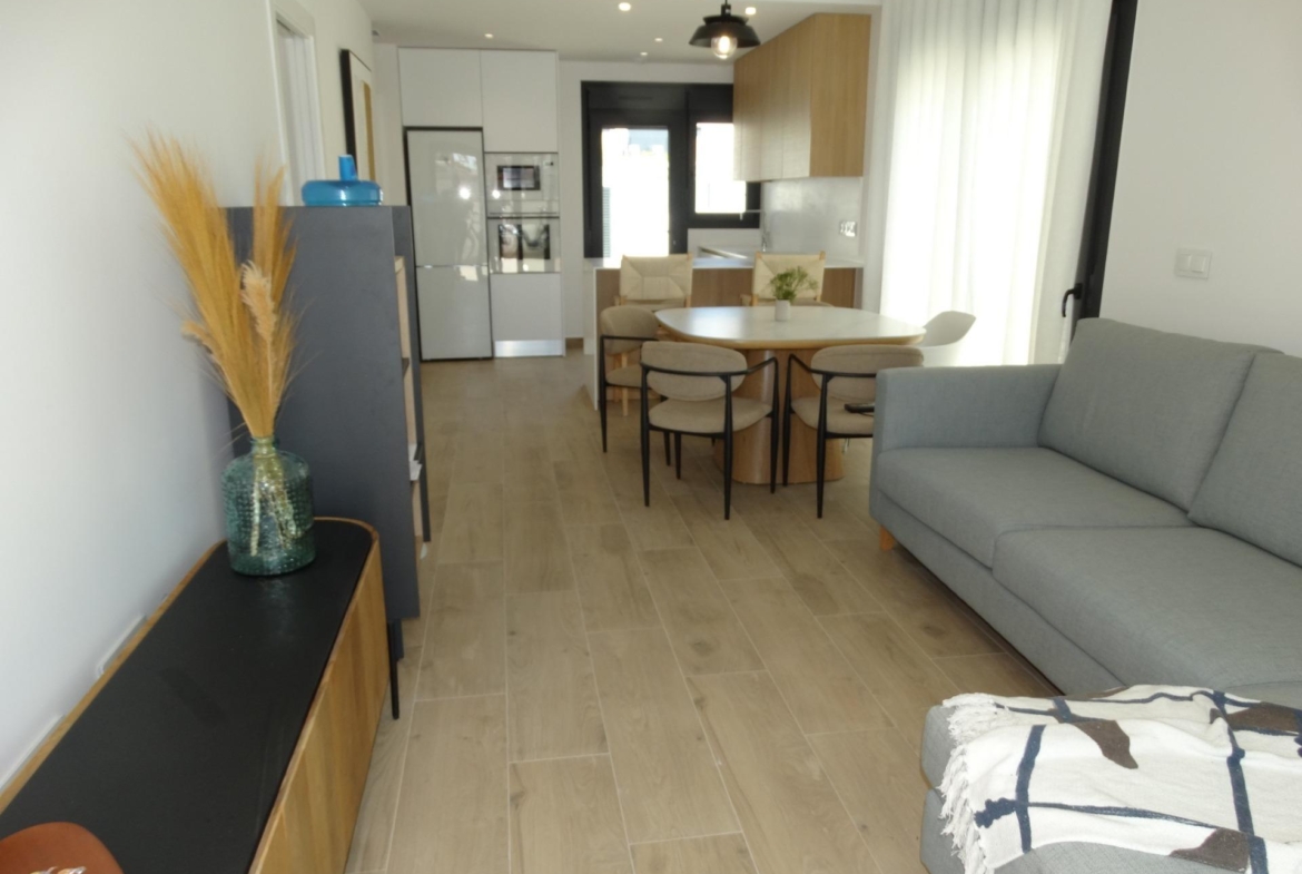 Bright modern open-plan living and dining area with sleek kitchen in luxury new build bungalows in Pilar de la Horadada.