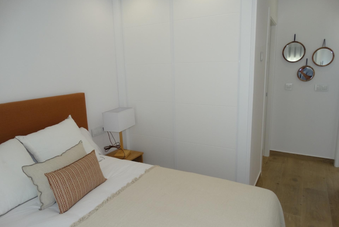 Modern-New-Build-Bungalows-for-Sale-in-Pilar-de-la-Horadada-13 Bright modern bedroom with elegant bedding and minimalist decor in a new build bungalow in Pilar de la Horadada
