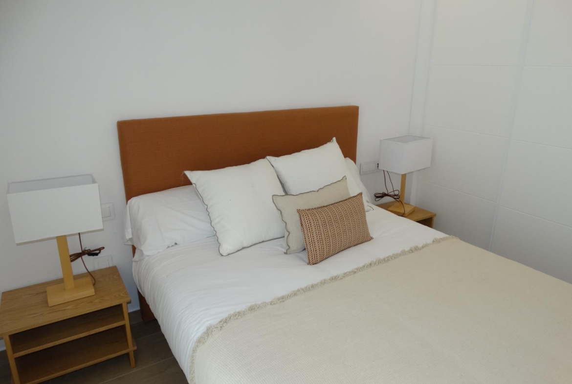 Modern-New-Build-Bungalows-for-Sale-in-Pilar-de-la-Horadada-14 Bright and cozy bedroom in modern new build bungalow for sale in Pilar de la Horadada with warm lighting and elegant furnishings