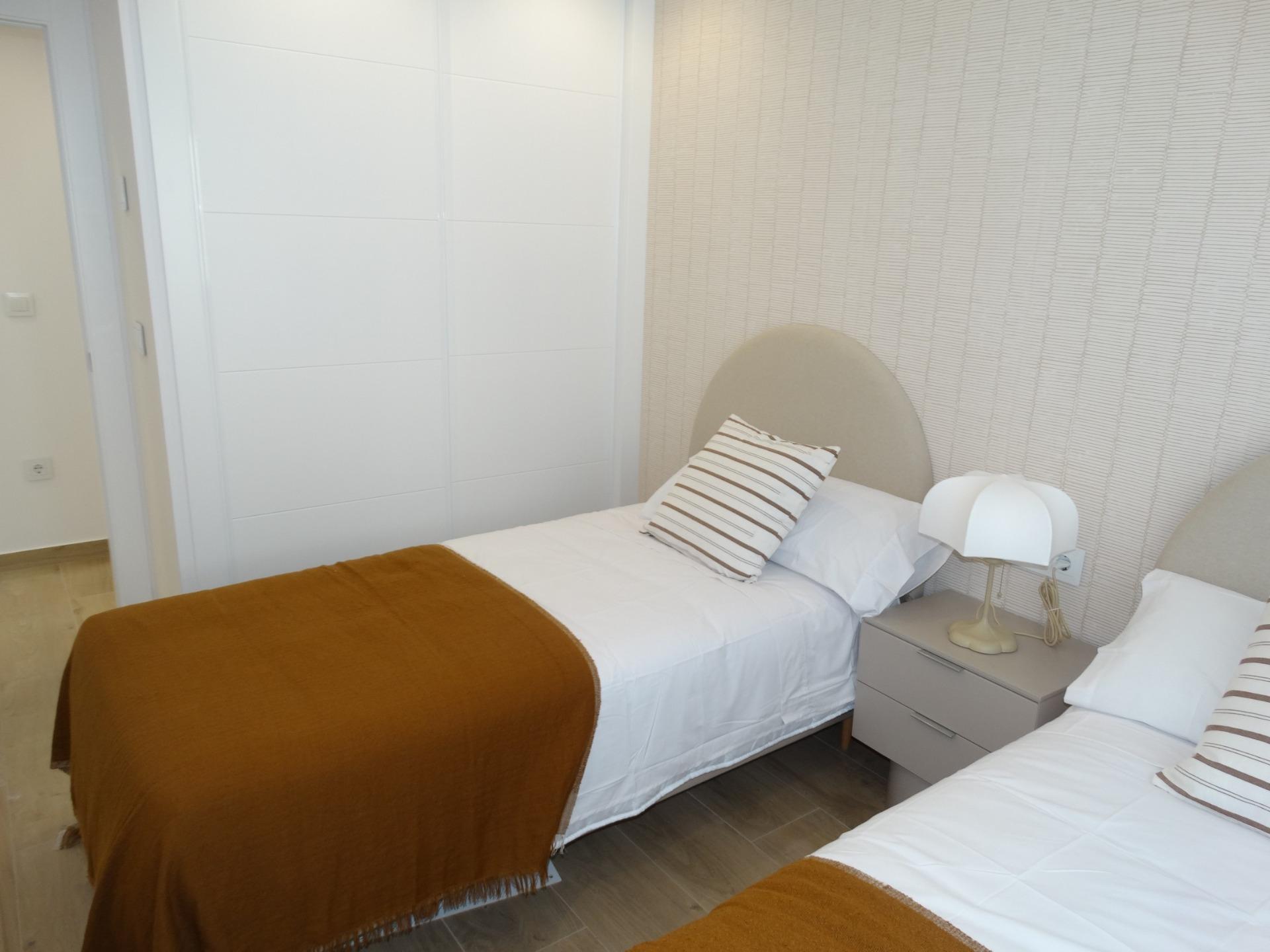 Bright, cozy twin bedroom with modern decor in a new build bungalow for sale in Pilar de la Horadada