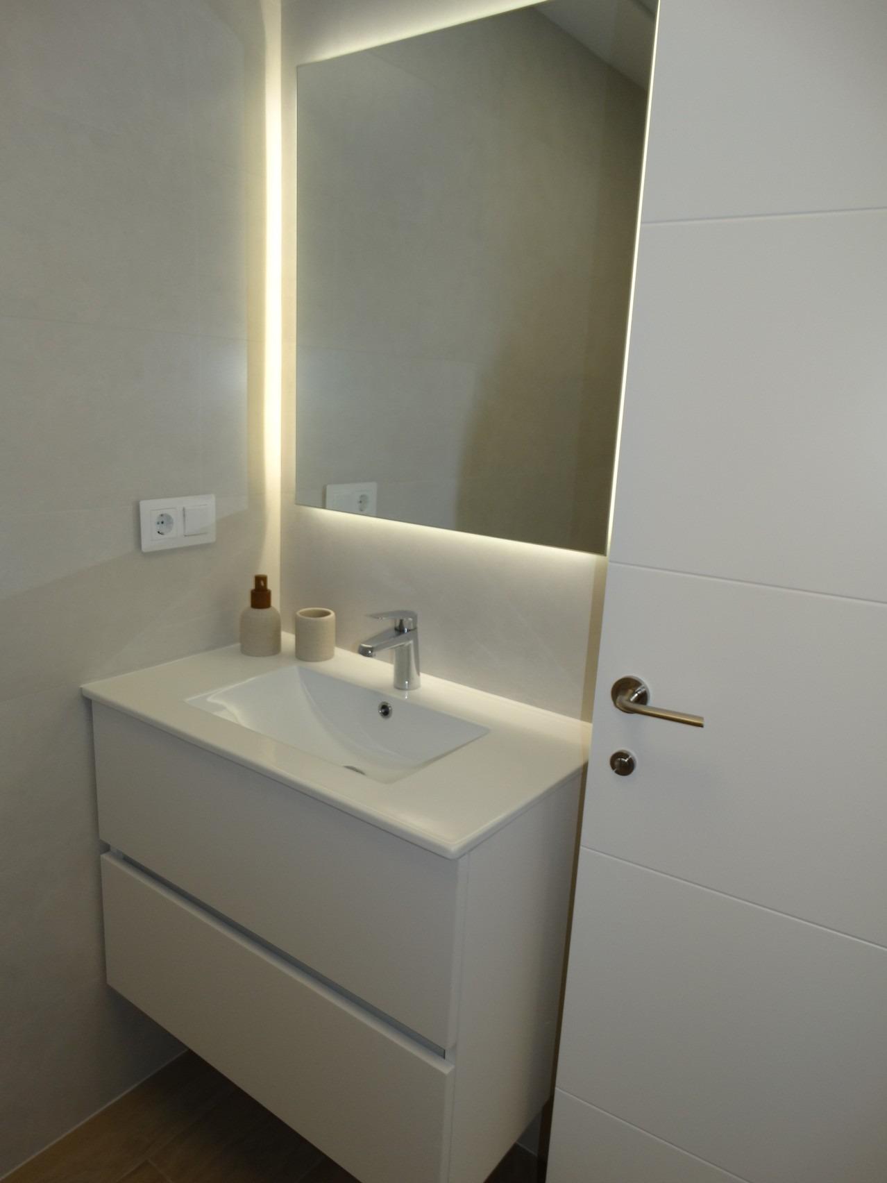Modern-New-Build-Bungalows-for-Sale-in-Pilar-de-la-Horadada-17 Sleek modern bathroom with illuminated mirror and minimalist vanity in new build bungalows, Pilar de la Horadada