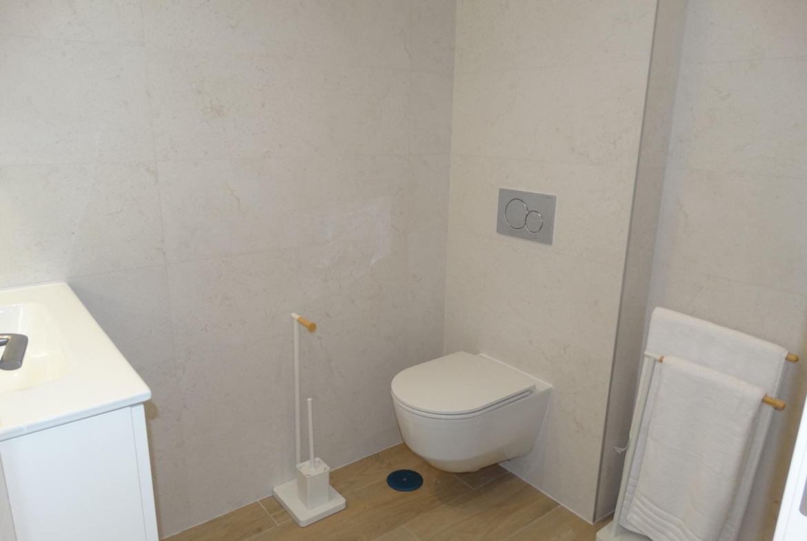 Modern-New-Build-Bungalows-for-Sale-in-Pilar-de-la-Horadada-20 Bright modern bathroom with sleek wall-mounted toilet and minimalist fixtures in new build bungalows, Pilar de la Horadada.