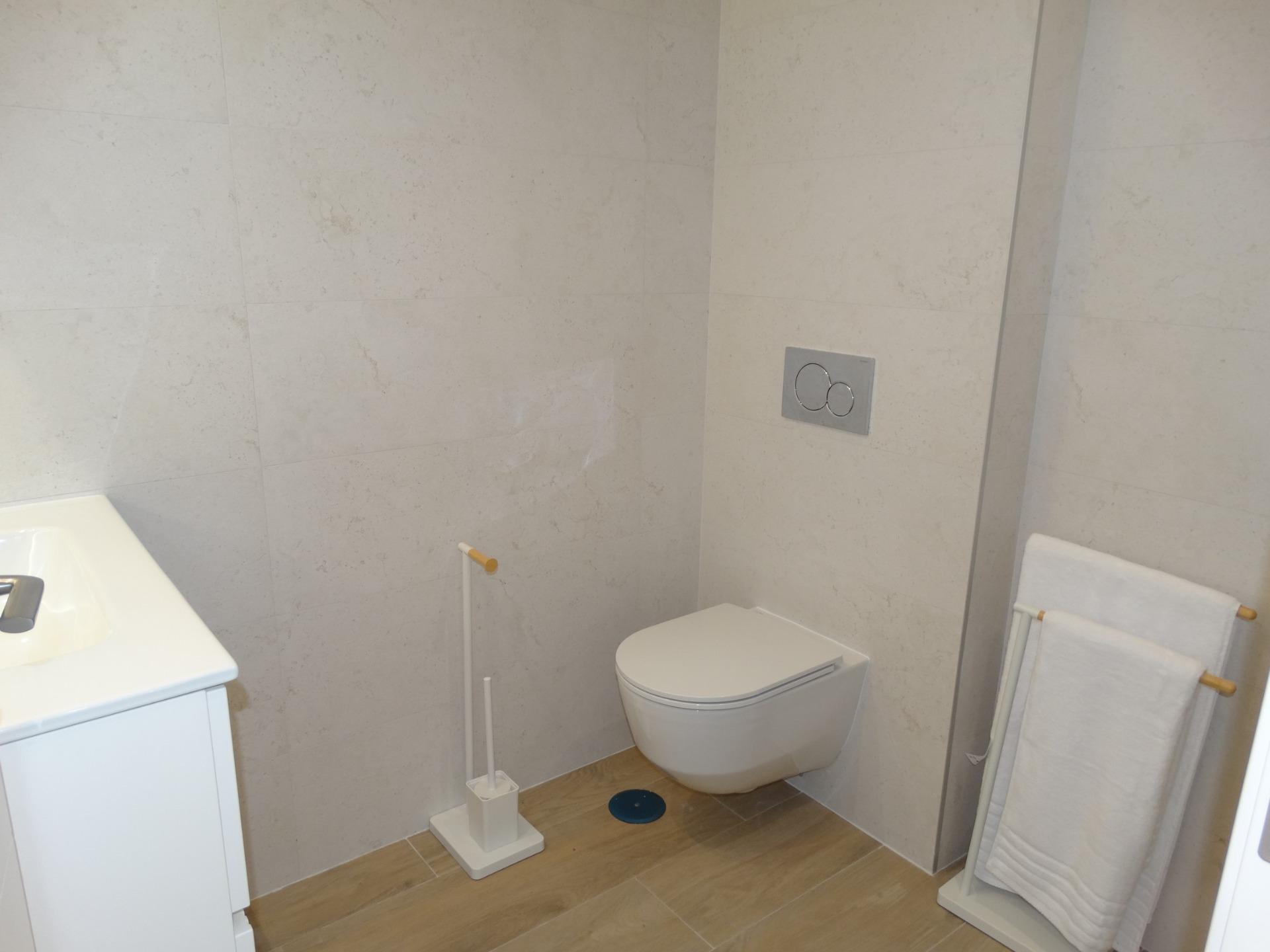 Modern-New-Build-Bungalows-for-Sale-in-Pilar-de-la-Horadada-20 Bright modern bathroom with sleek wall-mounted toilet and minimalist fixtures in new build bungalows, Pilar de la Horadada.