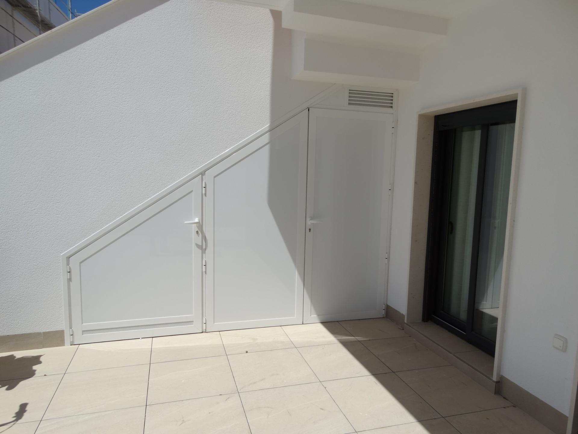 Modern-New-Build-Bungalows-for-Sale-in-Pilar-de-la-Horadada-26 Sun-drenched modern exterior terrace of luxury new build bungalows in Pilar de la Horadada with sleek white finishes.