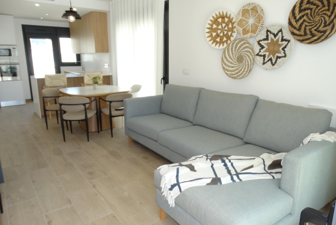 Bright, modern open-plan living and dining area in new build bungalows for sale in Pilar de la Horadada with stylish decor