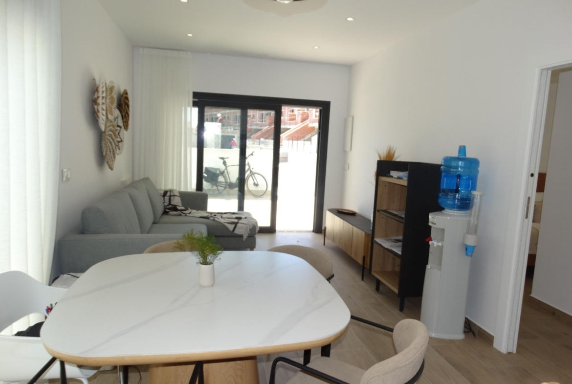 Modern-New-Build-Bungalows-for-Sale-in-Pilar-de-la-Horadada-9 Bright modern living and dining area in luxury new build bungalow with sleek decor in Pilar de la Horadada