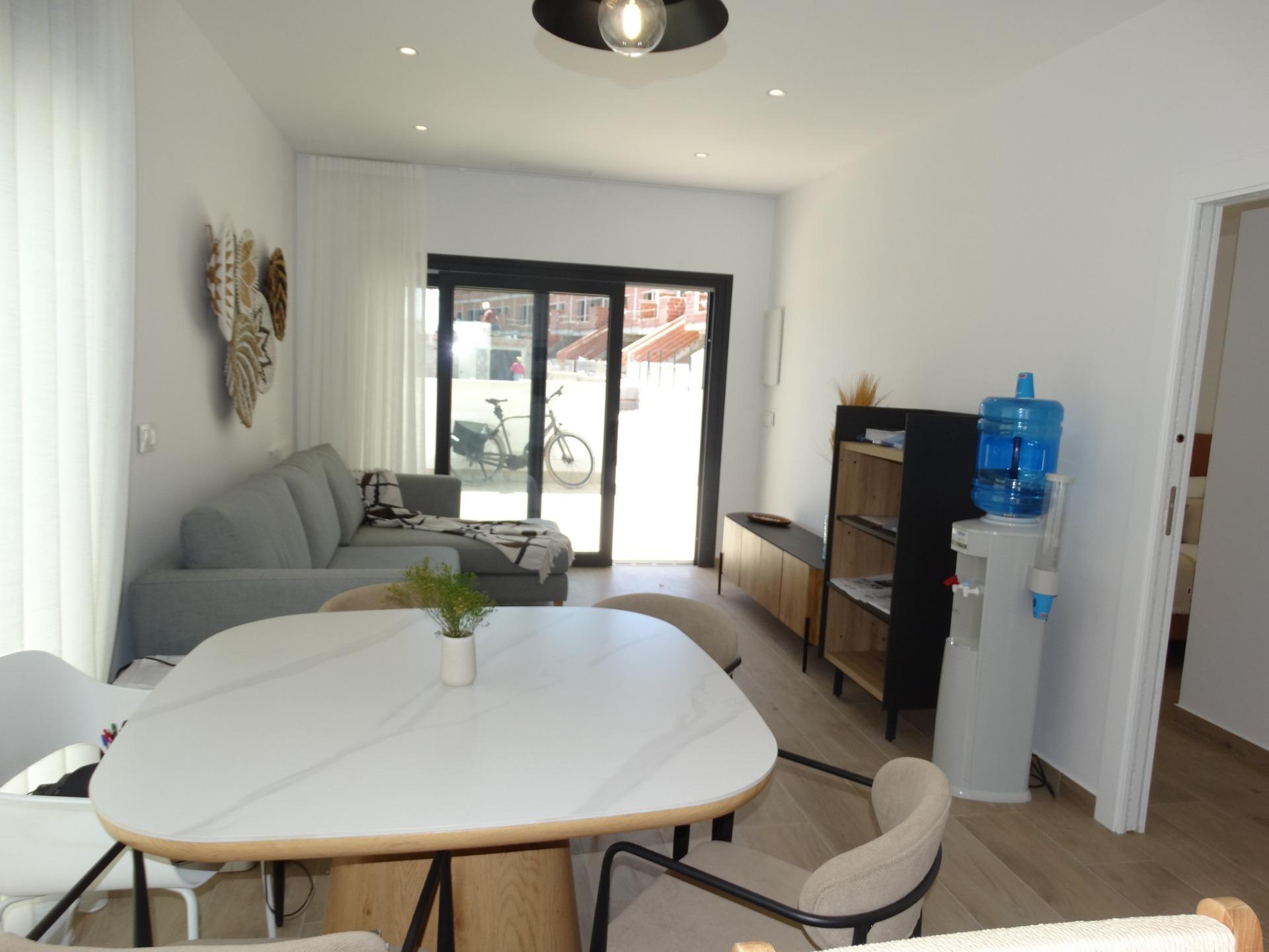 Modern-New-Build-Bungalows-for-Sale-in-Pilar-de-la-Horadada-9 Bright modern living and dining area in luxury new build bungalow with sleek decor in Pilar de la Horadada