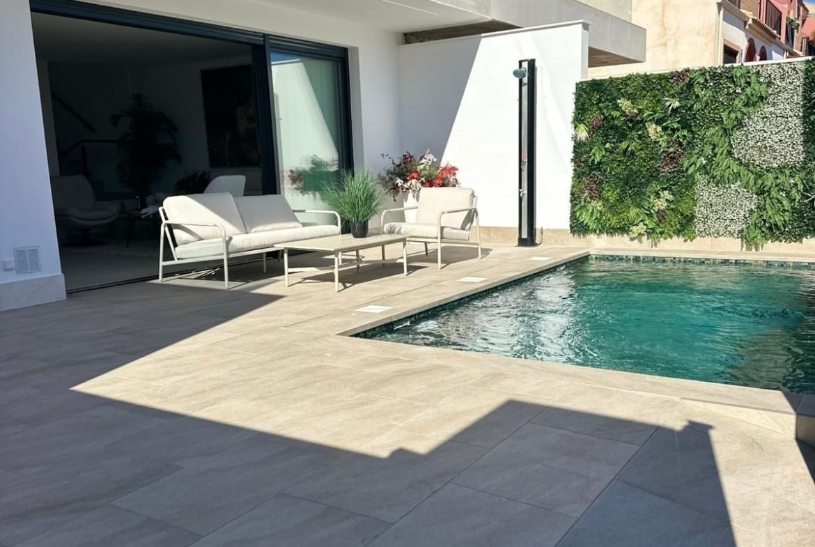 Sun-drenched terrace with modern outdoor seating and private pool in luxury new build villa in San Pedro del Pinatar, Costa Cálida.