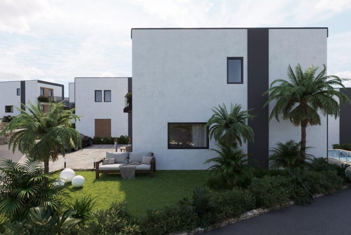 Modern energy-efficient 3 bedroom villa in Finestrat, Benidorm with lush landscaped garden and private outdoor seating area.