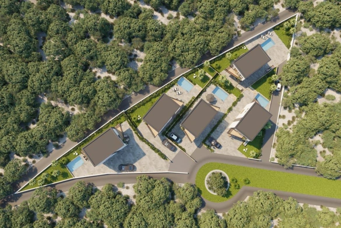 Aerial view of modern, energy-efficient 3-bedroom villas in Finestrat, each with landscaped gardens and private pools nestled in lush greenery.
