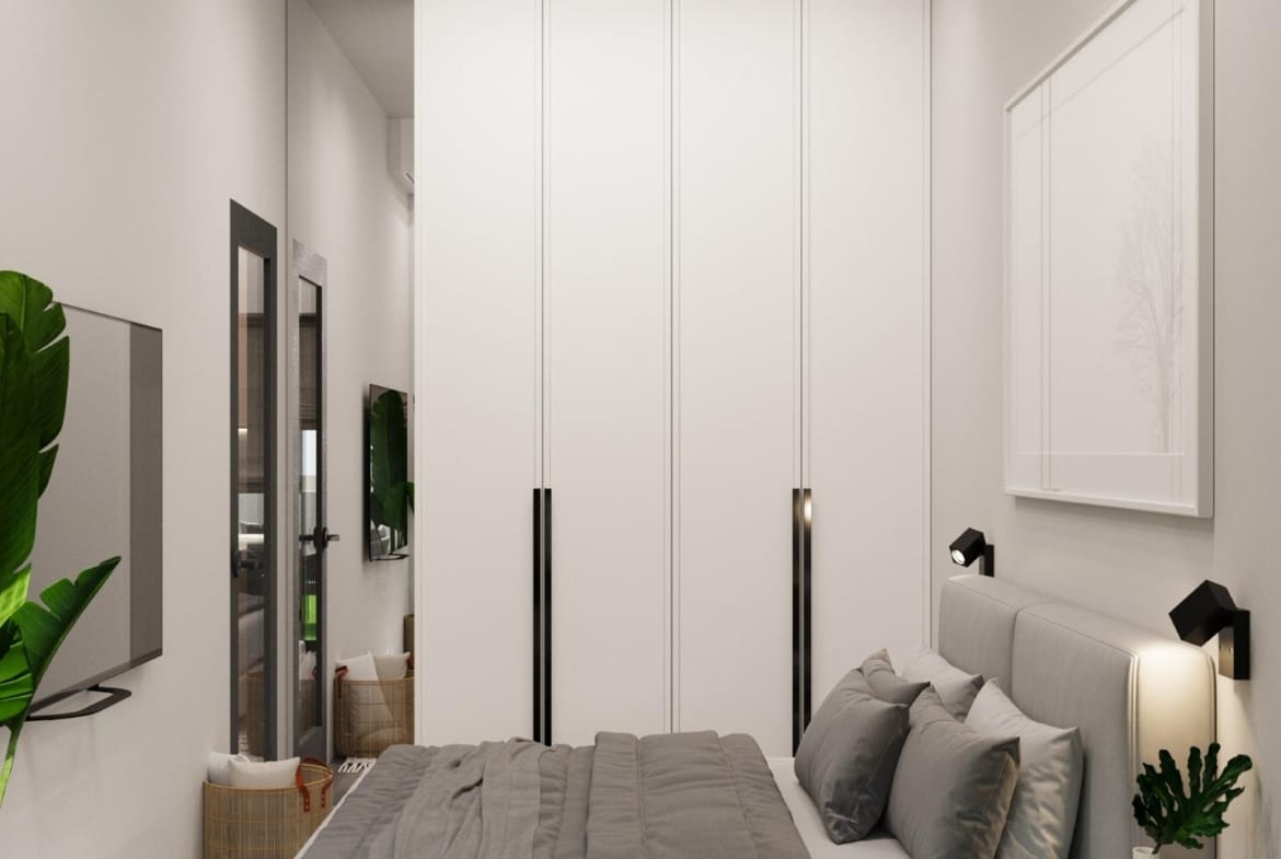 Bright, modern bedroom with sleek wardrobe and soft textiles in an energy-efficient 3-bedroom villa in Finestrat, Benidorm.