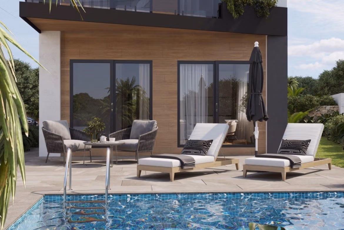 Modern-New-Build-Villas-in-Finestrat-with-Private-Pool-Near-Benidorm-3 Sun-drenched terrace with modern loungers and a sparkling private pool at an energy-efficient 3-bedroom villa in Finestrat, Benidorm.