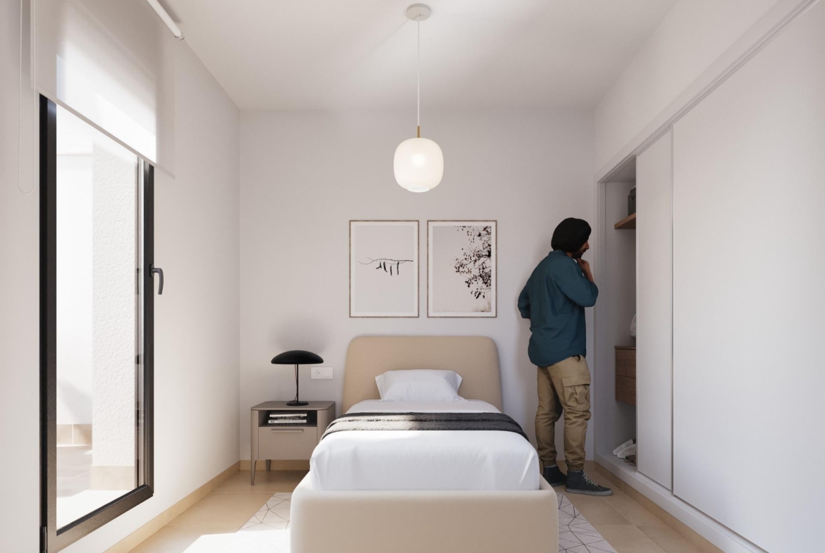 Bright and modern bedroom with sleek built-in wardrobe, minimalist decor, and natural light in a stylish 2-bedroom townhouse in Santa Rosalía.