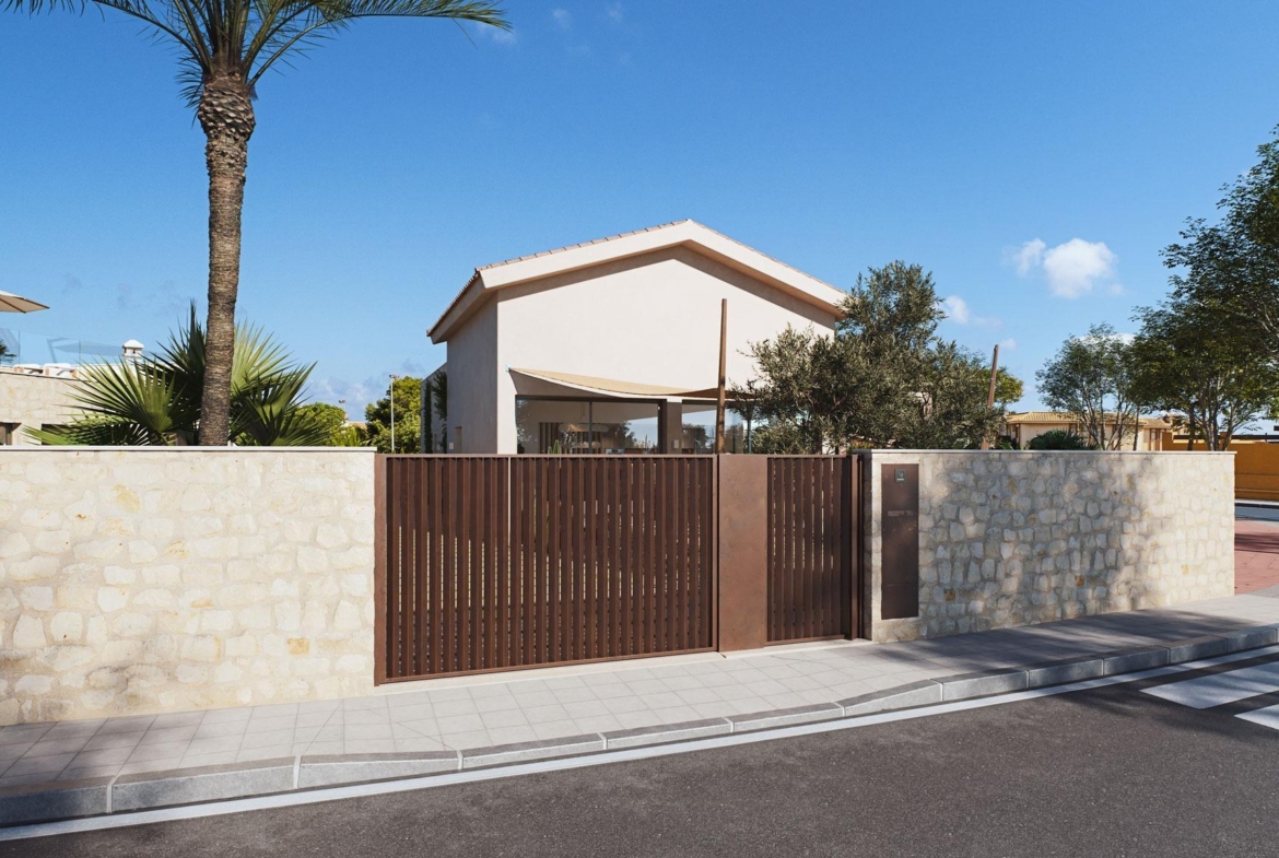 Modern villa exterior with stone wall and wooden gate under clear blue sky, just 150 meters from the beach in Cabo de Palos, Costa Cálida