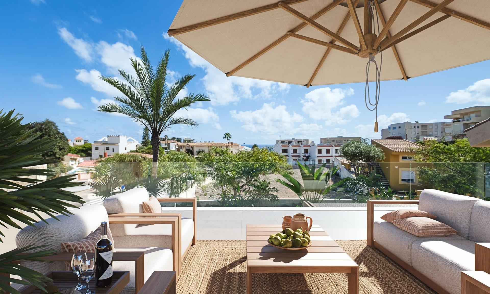Sunlit terrace with modern seating, lush greenery, and ocean views at a luxury villa in Cabo de Palos, Costa Cálida.