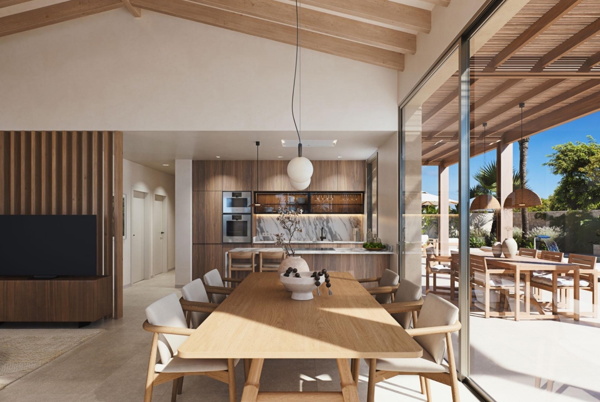 Bright open-plan dining and kitchen area with wooden accents and terrace access in modern villa near Cabo de Palos beach.