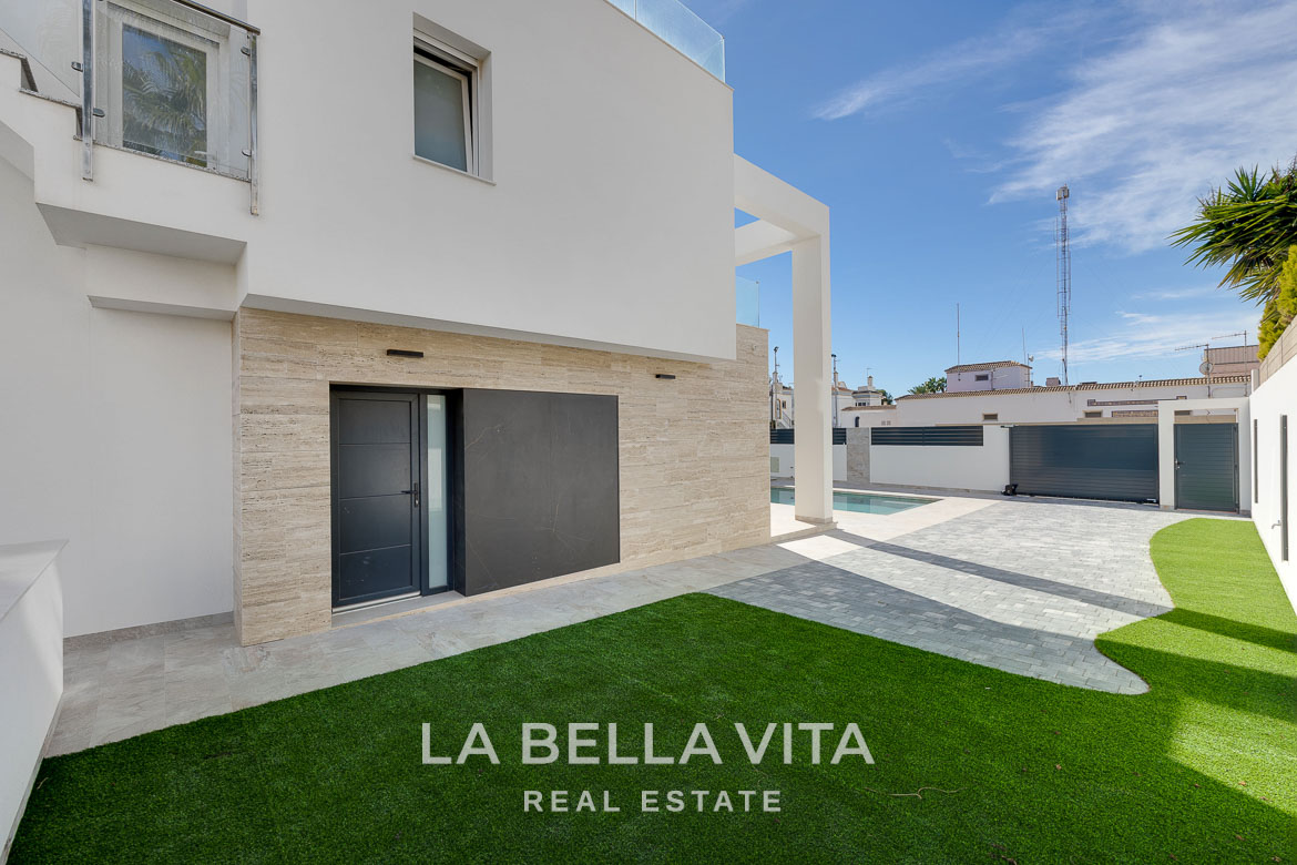 Modern villa with private pool, solarium and basement near La Mata beach, Torrevieja-11 Modern 4 bedroom villa exterior with sleek paved driveway and landscaped lawn in Torreblanca, Torrevieja