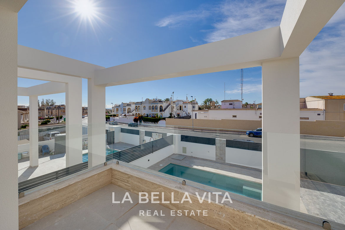 Modern villa with private pool, solarium and basement near La Mata beach, Torrevieja-12 Sunlit terrace overlooking the private pool and modern exterior of a luxurious 4-bedroom villa in Torreblanca, Torrevieja.