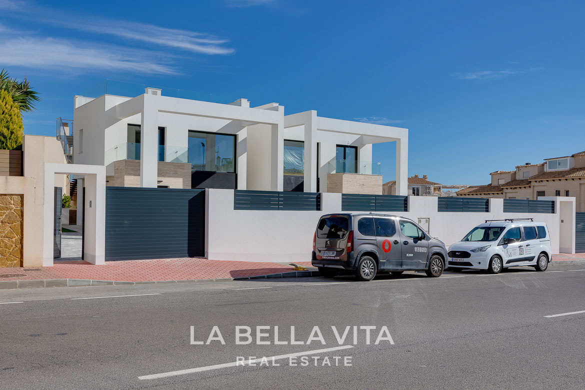 Modern villa with private pool, solarium and basement near La Mata beach, Torrevieja-23 Modern white 4-bedroom villa with sleek glass balconies and private pool in sunlit Torreblanca, Torrevieja neighborhood.