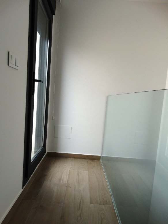 Bright modern corridor with sleek glass railing and wooden flooring in a 3 bedroom semi-detached villa in Pilar de la Horadada