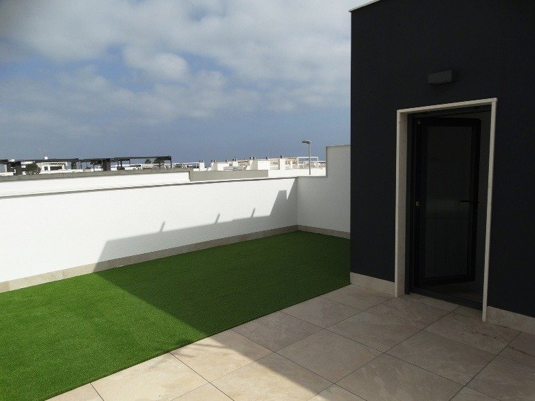 Spacious sun-drenched terrace with sleek tiled flooring in a modern 3-bedroom semi-detached villa in Pilar de la Horadada
