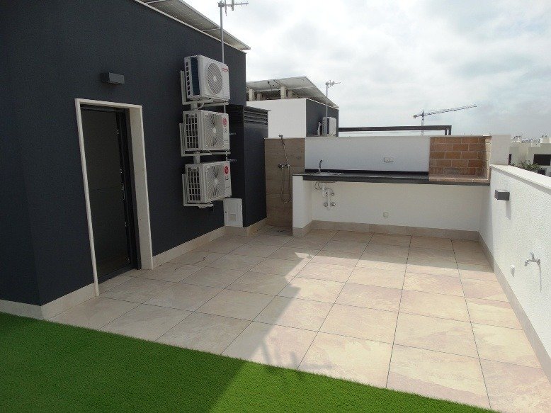 Bright spacious tiled terrace with modern outdoor kitchenette in 3 bedroom semi-detached villa in Pilar de la Horadada