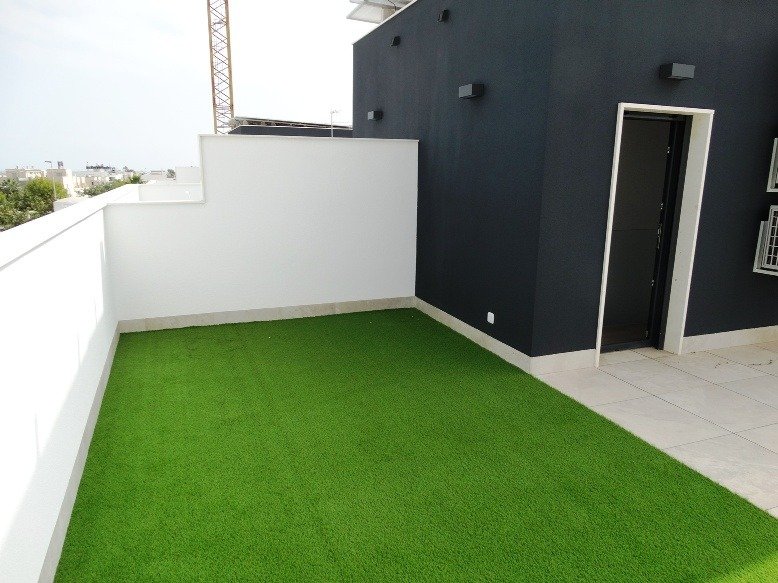 Spacious sun-drenched terrace with artificial grass in modern 3-bedroom semi-detached villa in Pilar de la Horadada