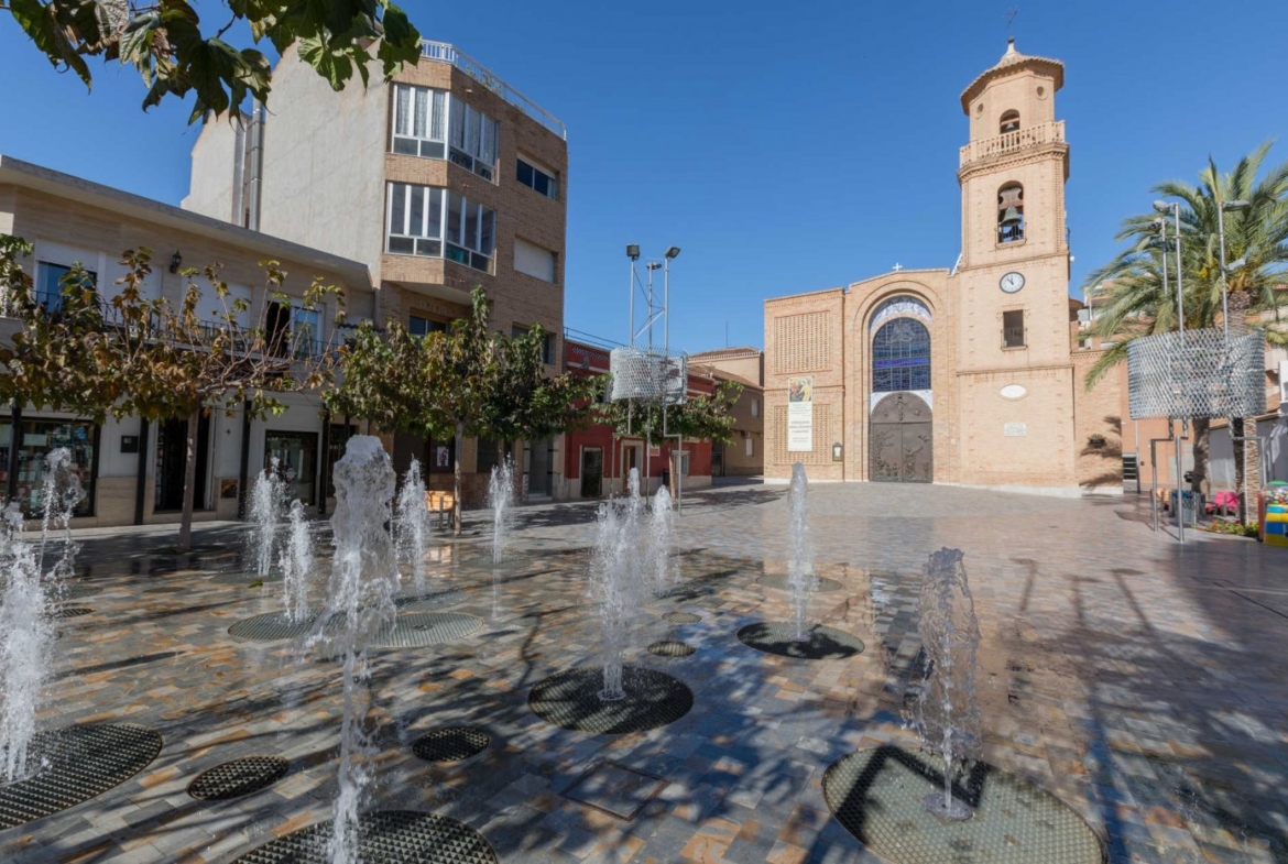 Sunlit historic square with fountains and charming architecture near Pilar de la Horadada luxury villa for sale.