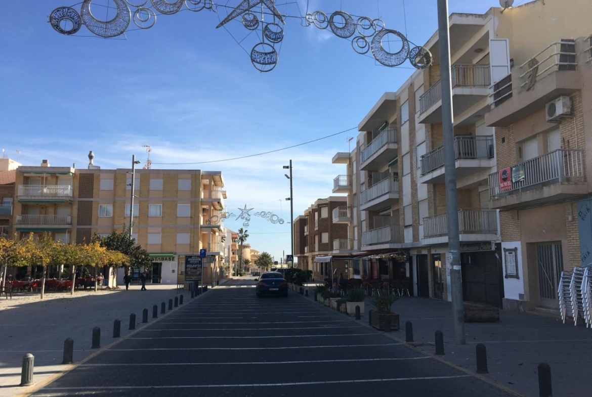 Sunlit urban street view in Pilar de la Horadada near modern new build 3 bedroom semi-detached villas with private pools.