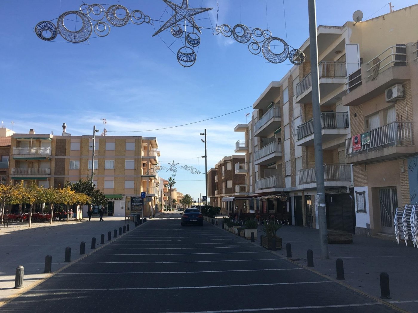 Sunlit urban street view in Pilar de la Horadada near modern new build 3 bedroom semi-detached villas with private pools.
